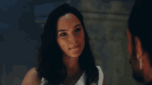 a woman in a white dress is looking at a man