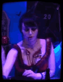 a woman with blood coming out of her chest is wearing a black shirt that says 20