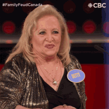 a woman with a name tag that says betty stands in front of a microphone