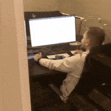 a man sits at a desk with an hp computer