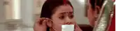 a woman is covering a woman 's mouth with a piece of paper .