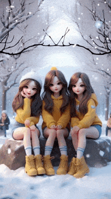 three dolls are sitting on a rock in the snow wearing yellow
