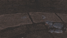 a person is holding a large sword in front of a stone wall