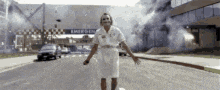 a nurse is standing in front of an emergency room