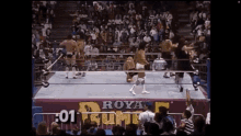 a group of wrestlers are in a ring with a sign that says royal rumble