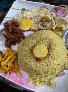 a plate of food with rice eggs and vegetables