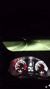 a car is driving down a highway at night and the speedometer shows that the car is going at a very high speed