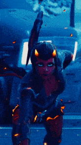 a woman with horns on her head is holding a sword