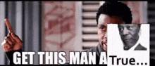a man is pointing at a picture of a man with the words get this man a true