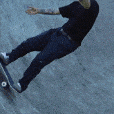 a skateboarder is doing a trick on a ramp with a tattoo on his arm