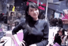 a woman is standing in front of a store with a sign that says store on it