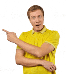 a man in a yellow shirt points to the side