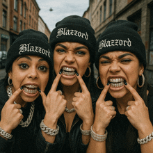 three women wearing black beanies with the word blazord on them