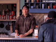 a man standing behind a counter with a sign that says dr pflaumisan