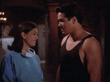 a man and a woman are looking into each other 's eyes and smiling