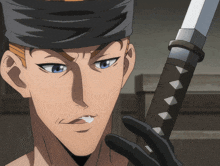 a man with a bandana on his head holds a sword in his hand