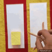 a person is holding a pencil next to a yellow sponge on a yellow and red background .