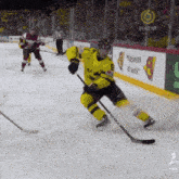 a hockey game is being played in front of an ad for direct