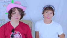 a man wearing a pink cowboy hat and a shirt that says ' s fish harbor maine ' on it