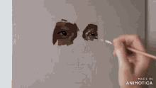 a painting of a woman 's face is being painted with the words made in animotica below it