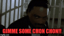 a man in a suit and tie is talking on a cell phone in a prison cell .