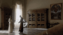 a man in a white robe is standing next to another man