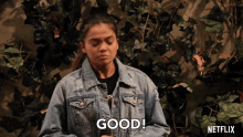 a woman in a denim jacket says " good " in front of a netflix logo