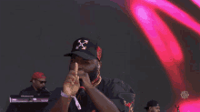 a man wearing a hat with an x on it