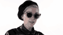 a woman wearing sunglasses and a black hat is holding a cigarette