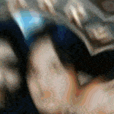 a blurry picture of a person 's face with the letter k on the bottom right