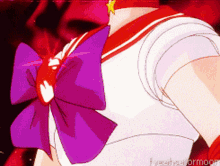 a close up of a sailor moon character with a red bow