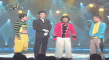 a group of people standing on a stage with a sign that says ' a '