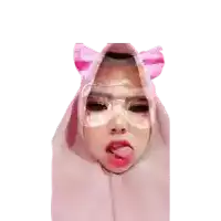 a woman wearing a pink hijab and glasses sticks her tongue out