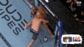 two men are fighting in a boxing ring with a can of 2 shots in every can