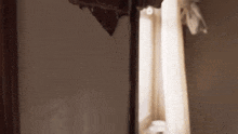 a woman is looking at herself in the mirror in a room .