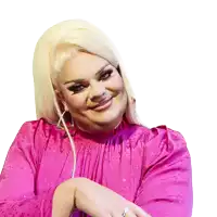 a woman with blonde hair wearing a pink dress