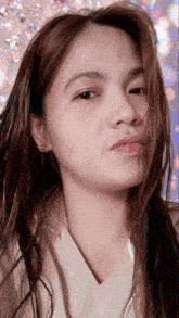 a close up of a woman 's face with a blurred background