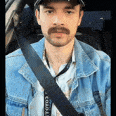 a man wearing a denim jacket and a lanyard that says toyota on it