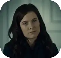 a close up of a woman 's face in a dark room