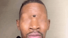 a close up of a man 's face with three eyes .