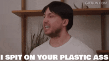 a man says i spit on your plastic ass in front of a shelf