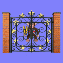 a monkey with a british flag on his chest is standing behind a wrought iron gate
