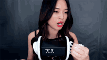a woman wearing a pair of ear buds with the letters aa on the front