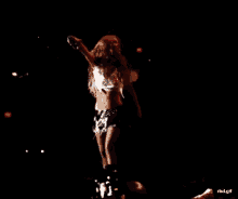 a person taking a picture of a woman on a stage with the url rbl.gif