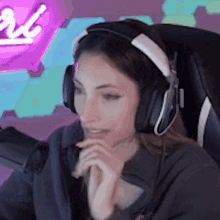 a woman wearing headphones is sitting in front of a computer .