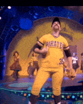 a man is wearing a yellow pirates jersey