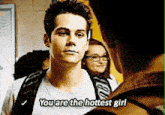 a man with a backpack is talking to another man and says you are the hottest girl