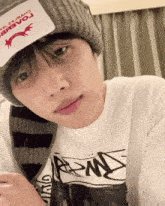 a young man wearing a beanie and a t-shirt that says bravoj