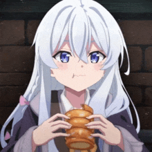 a girl with long white hair and blue eyes is holding a stack of bread in her hands .