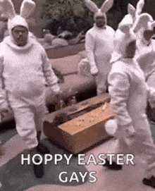 a group of men in bunny costumes are standing in a living room .